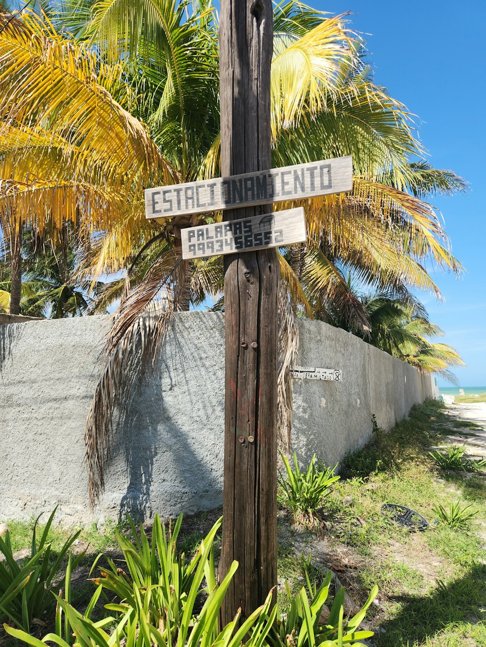 a wooden pole with a street sign on it