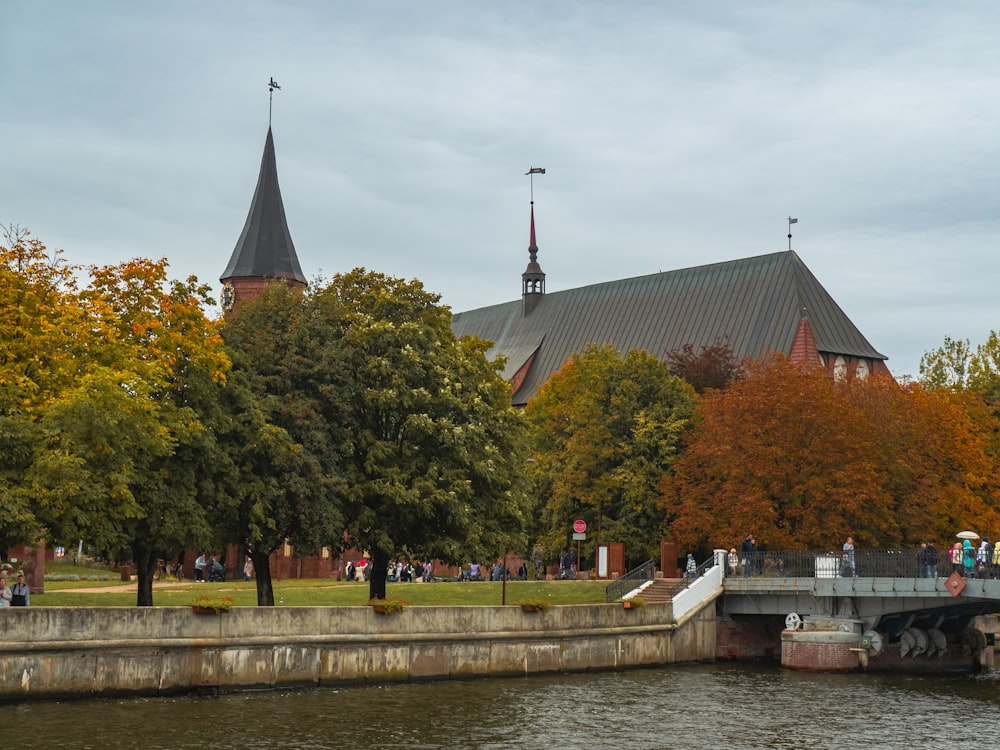 a river with a bridge and a church in the background