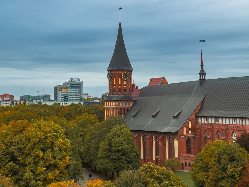 a church with a steeple surrounded by trees