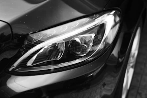 Close-up of a Mazda3's headlight reflecting the art of light in a minimalist setting