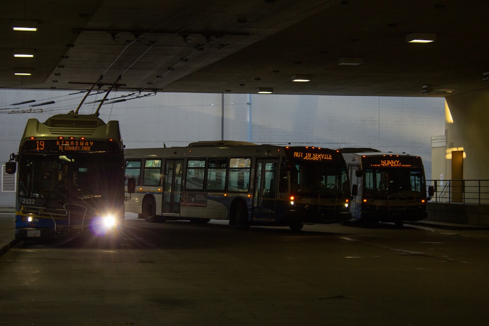 a couple of buses that are sitting in a parking lot