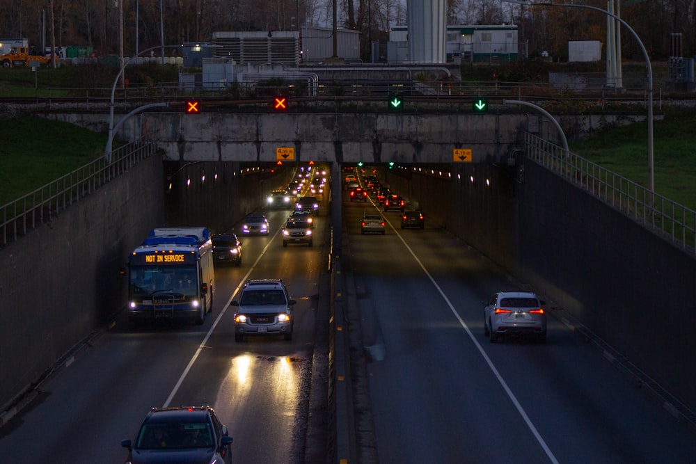 a highway filled with lots of traffic under a bridge