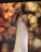 A woman in a white gown is singing passionately on stage, holding a microphone. She stands in front of a vivid, abstract background with swirling patterns and warm colors. The stage setting includes another microphone on a stand visible beside her.