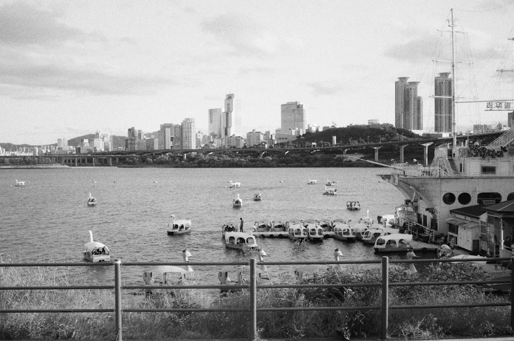 a black and white photo of boats in the water