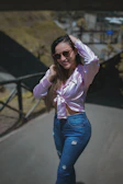 Casual street style outfit worn by a young woman smiling on a sunny day.