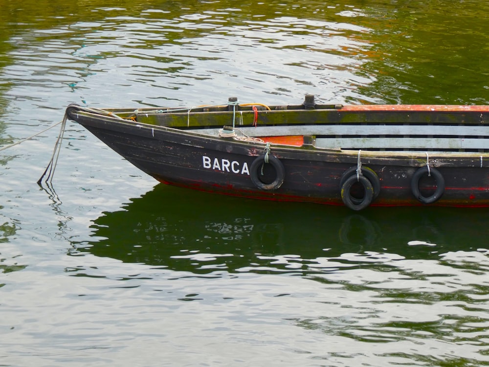 a small boat floating on top of a body of water