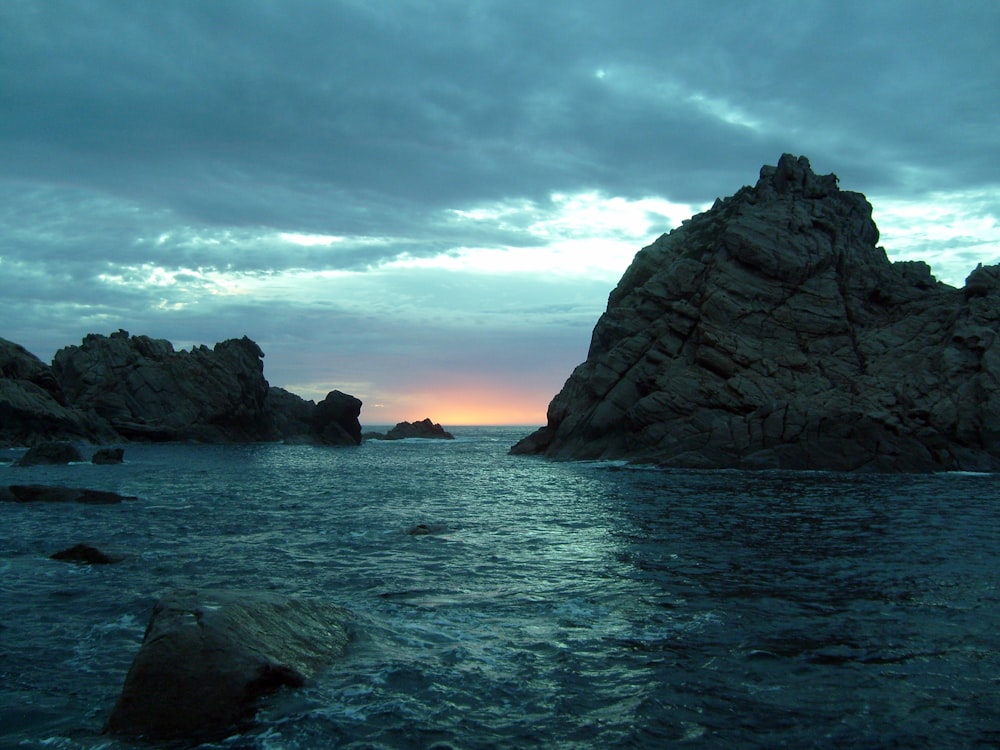 a rock outcropping in the middle of a body of water