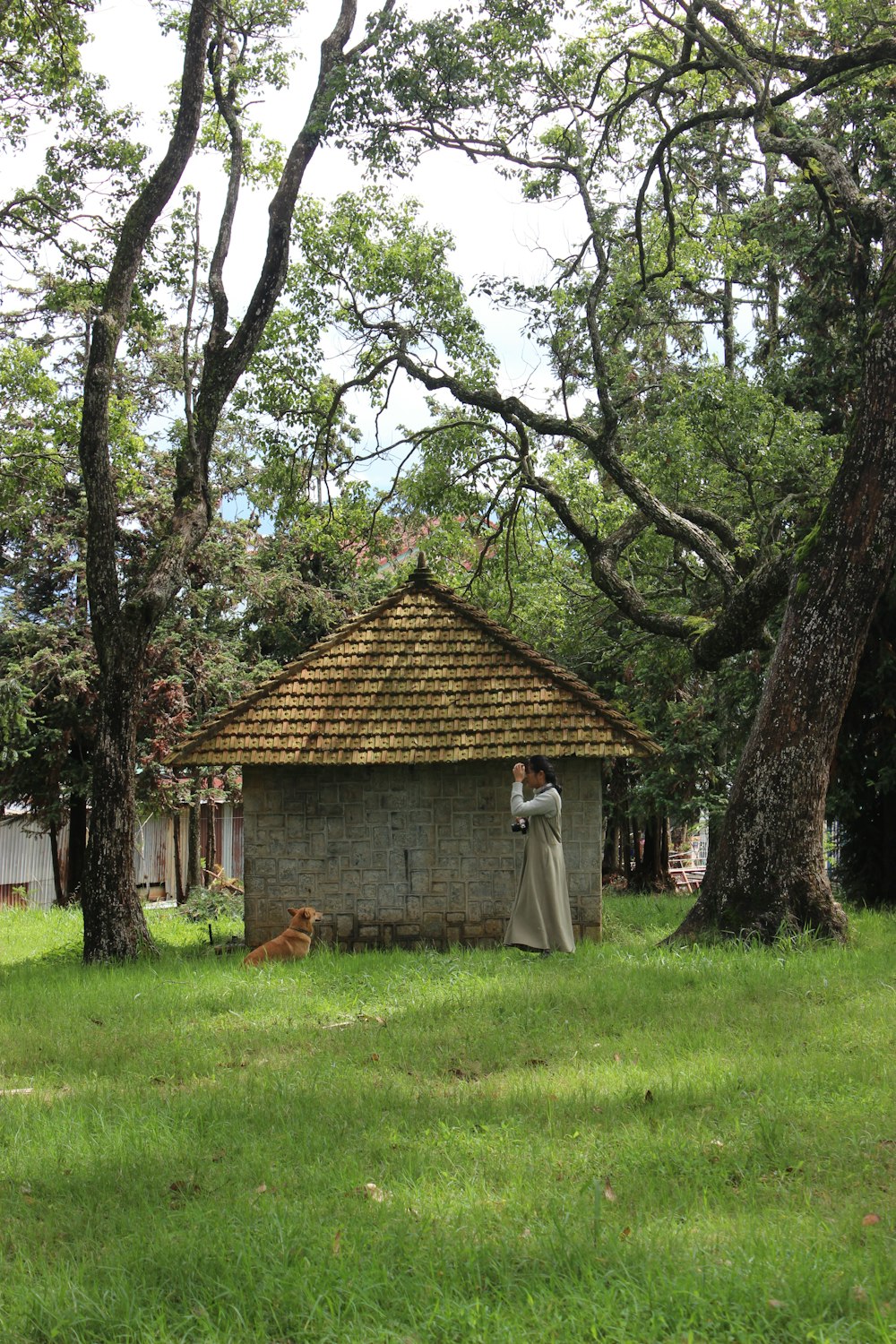 a man standing in front of a small building