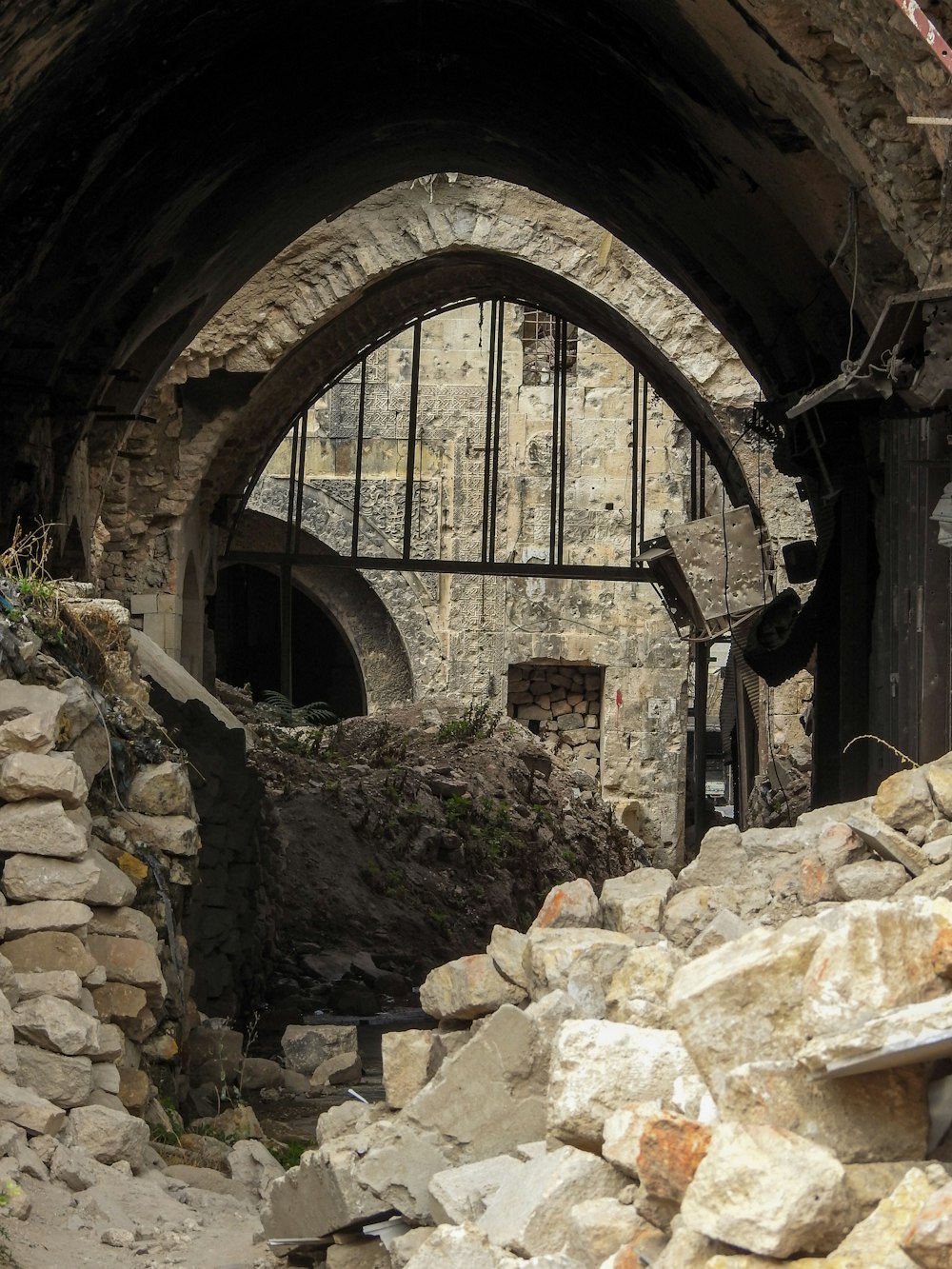 a large pile of rubble in front of a stone building