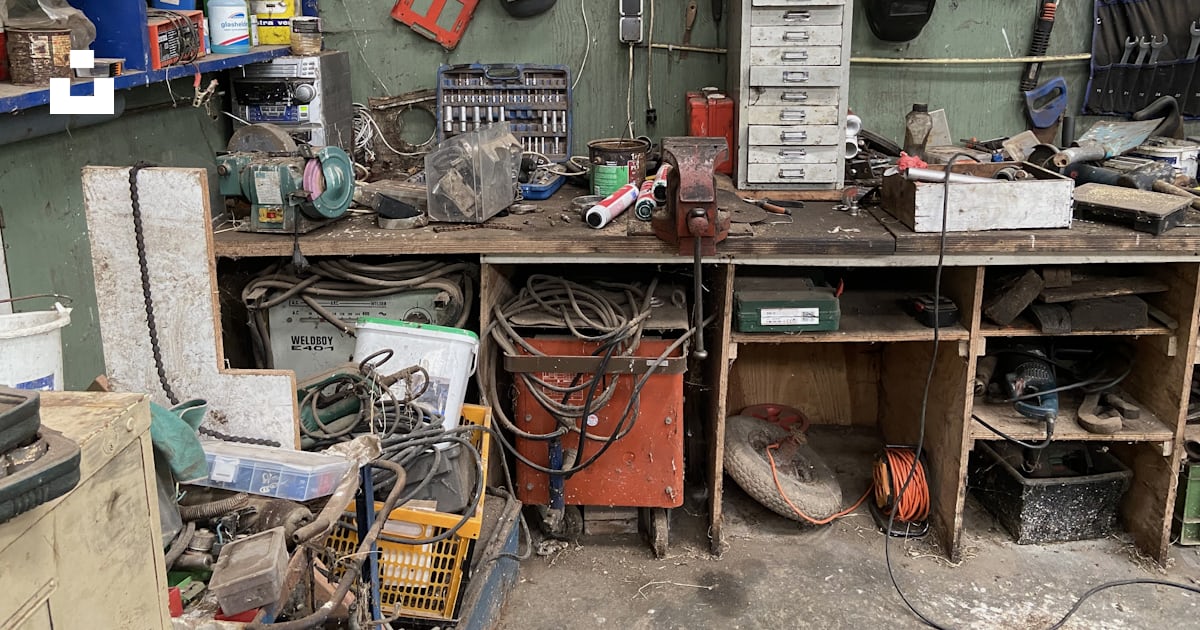 A workbench filled with lots of clutter and tools photo – Free ...