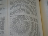A close-up of an open book, with emphasis on a section discussing Daniel interpreting a dream. The text is in English and the page appears slightly curved.
