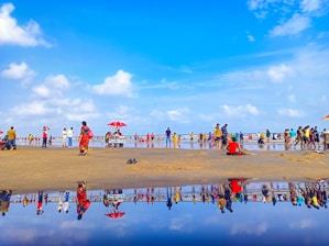 A vibrant beach scene with people wearing colorful summer clothes from agohha.