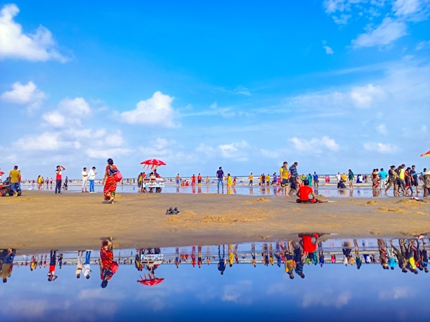 A vibrant beach scene with people wearing colorful summer clothes from agohha.