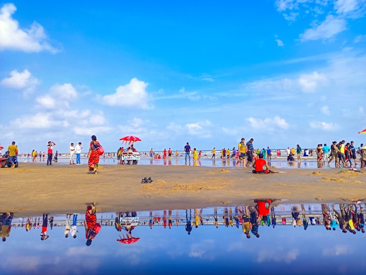 A vibrant snapshot of a popular lifestyle influencer engaging with fans at a sunny San Diego beach event.