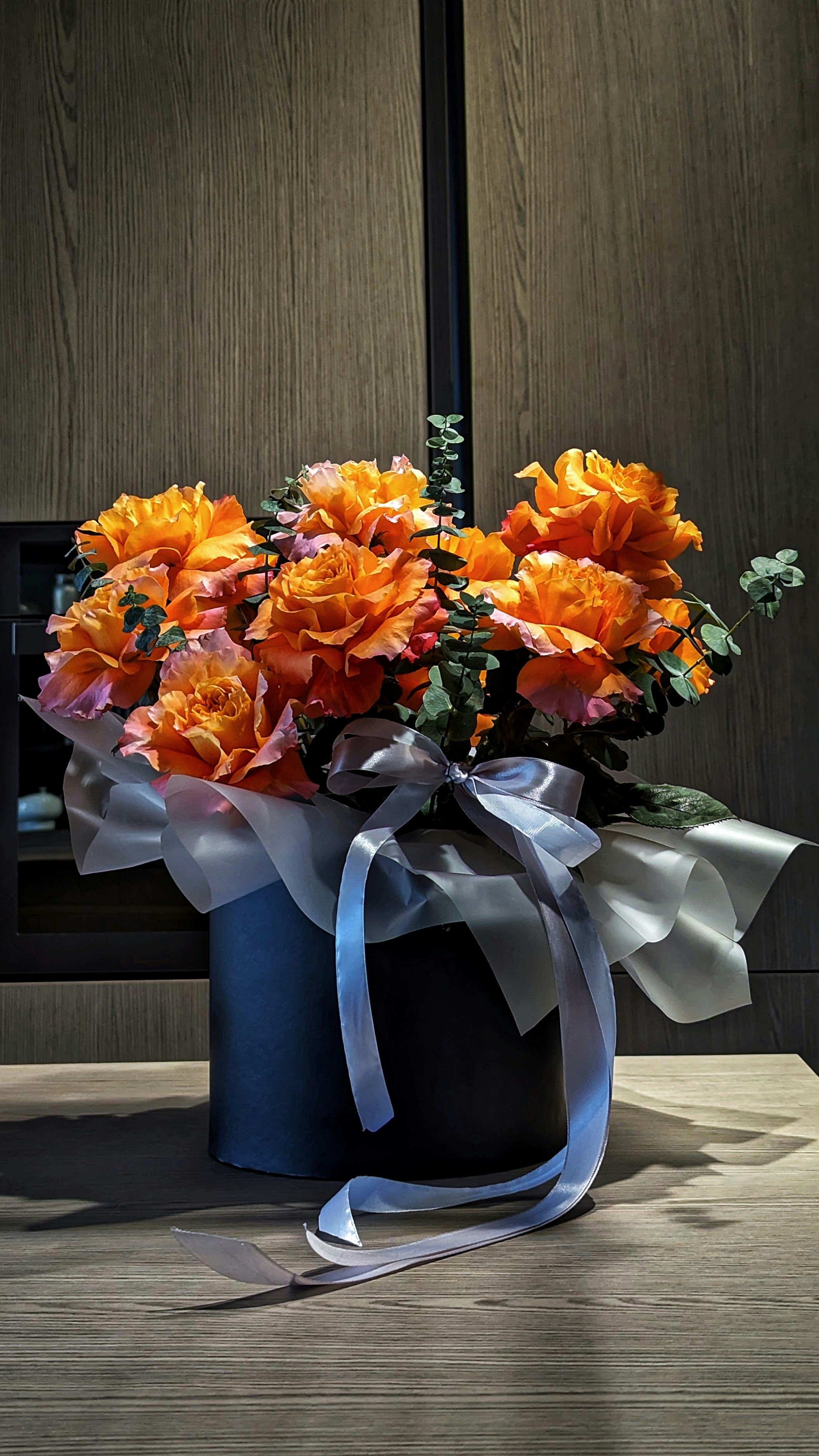 White phalaenopsis orchids in a luxury black gift box with satin ribbon