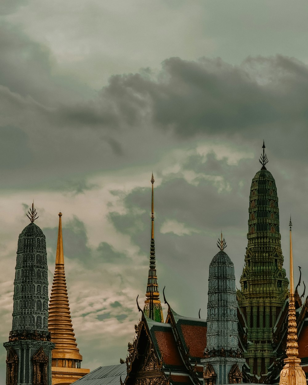 a group of tall buildings sitting under a cloudy sky