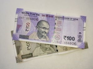 two indian currency bills laying on top of each other