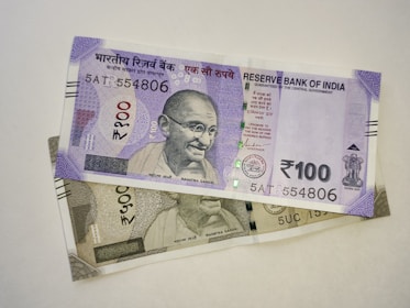 two indian currency bills laying on top of each other