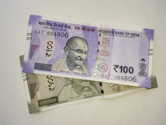 two indian currency bills laying on top of each other