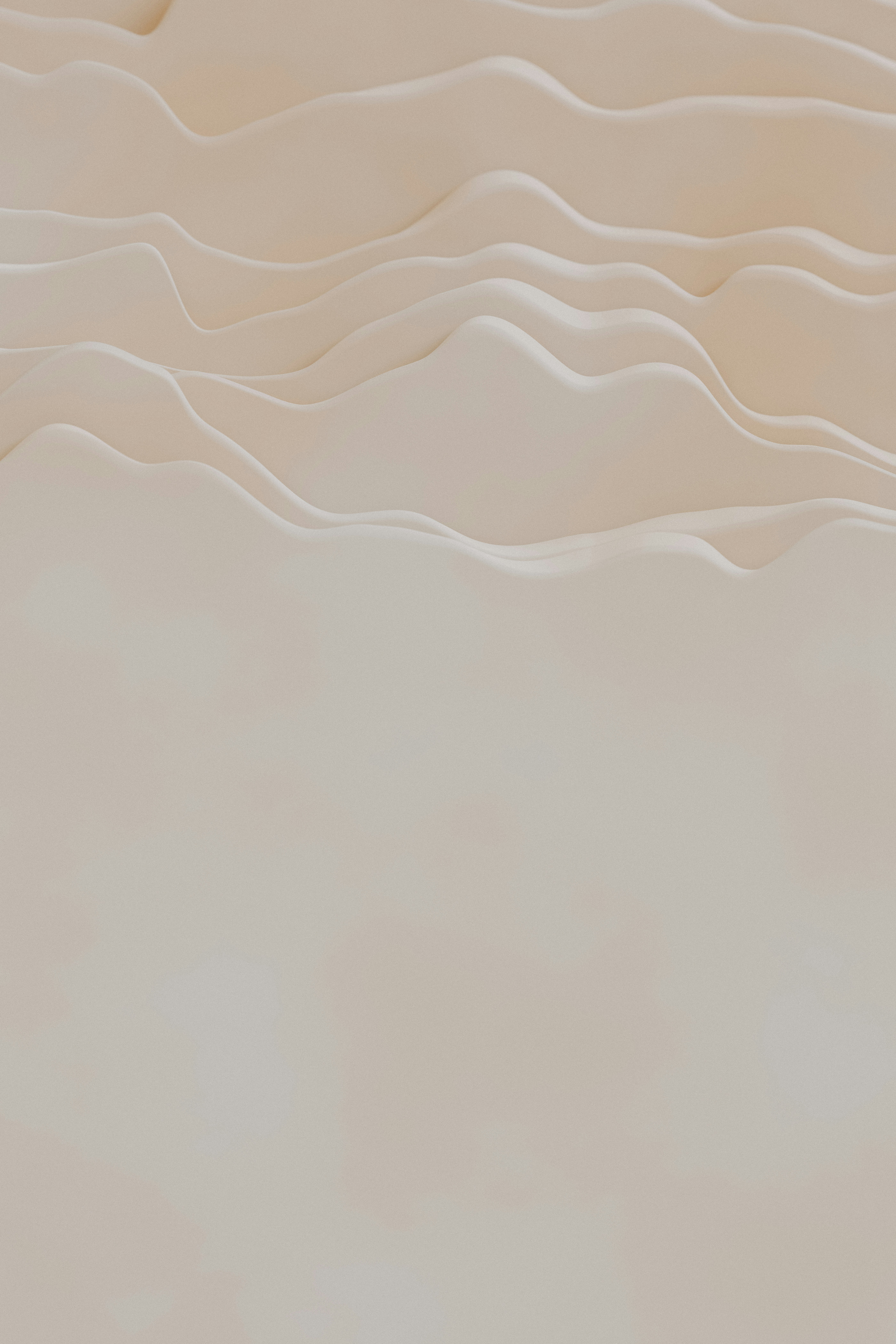 a bird flying over a sandy beach next to the ocean