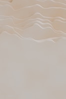 Warm earth-toned textures blending with white space, evoking calm and depth.