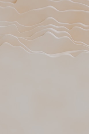 Softly blurred organic forms in muted sands and warm whites, suggesting tranquility and natural flow.