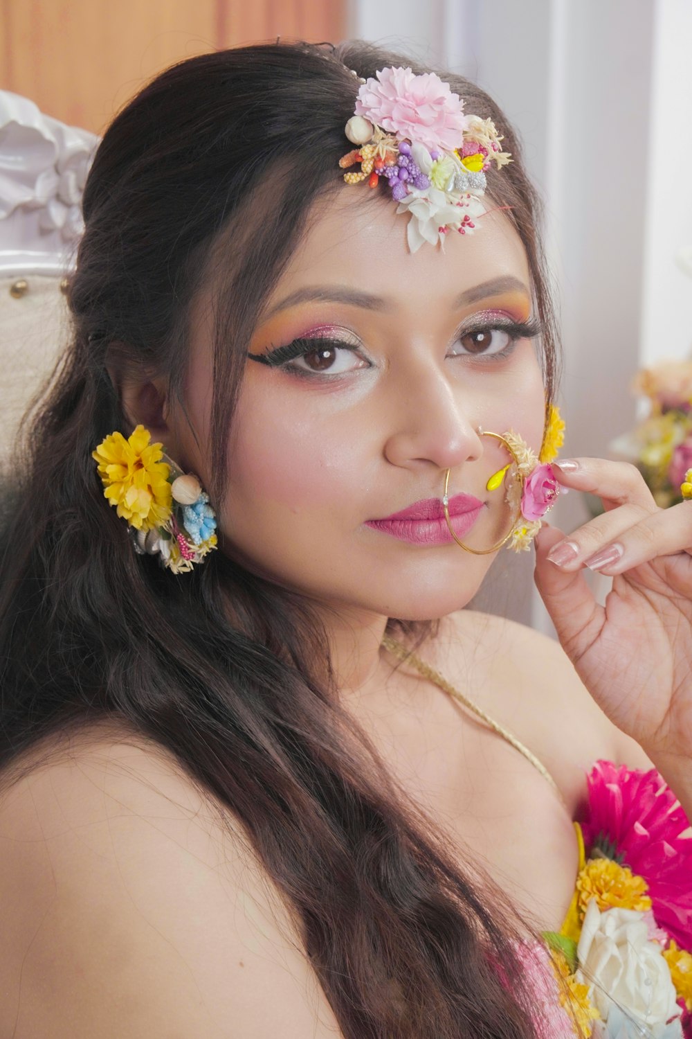 a woman with flowers in her hair posing for a picture