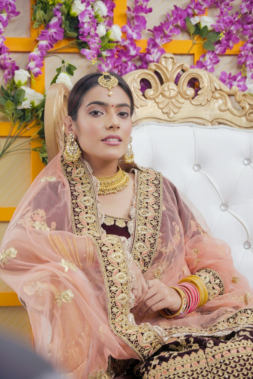 a woman in a bridal outfit sitting on a couch