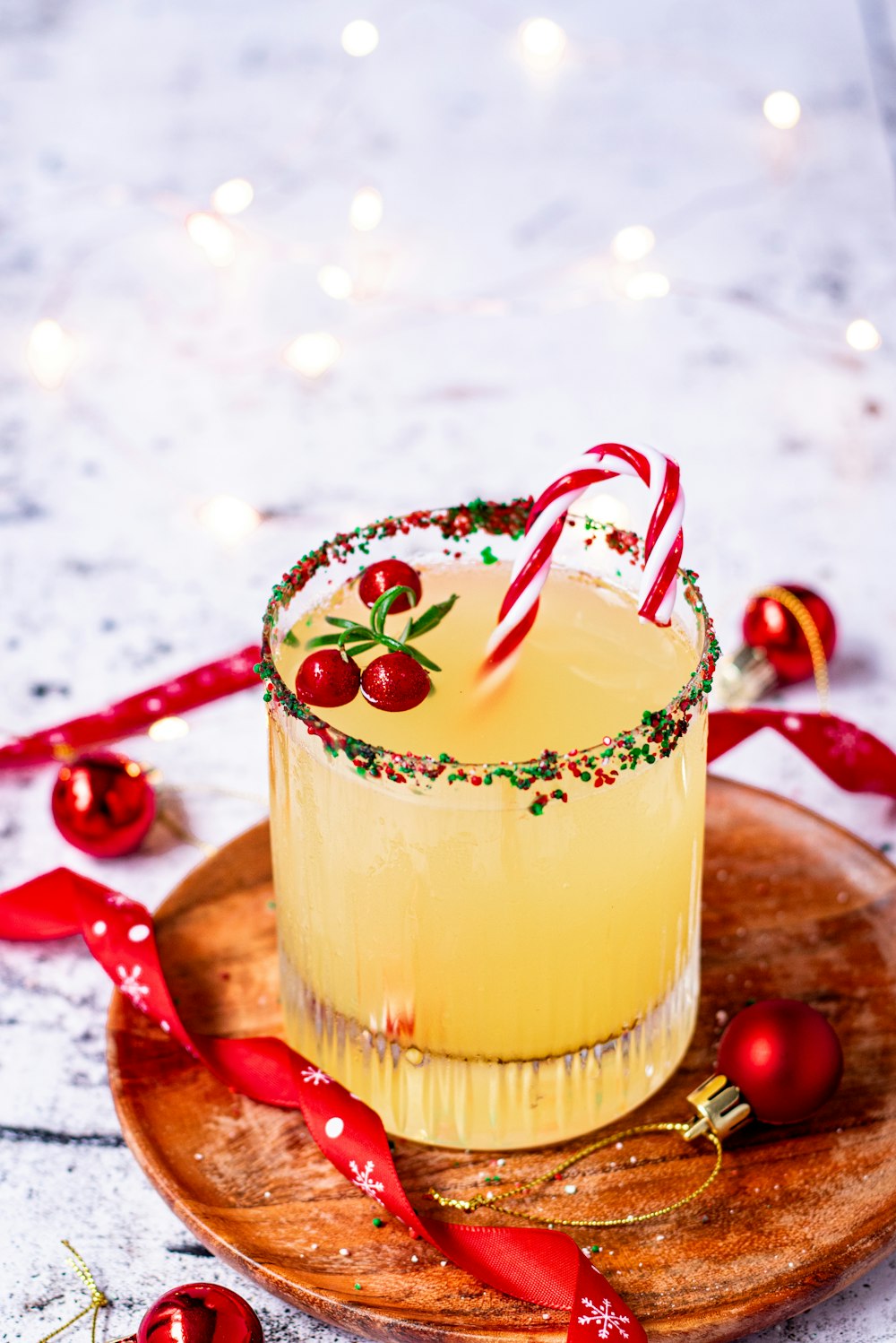 a drink with a candy cane in a glass