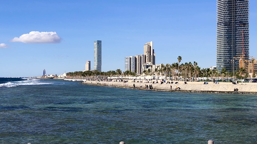 a beach next to a city with tall buildings
