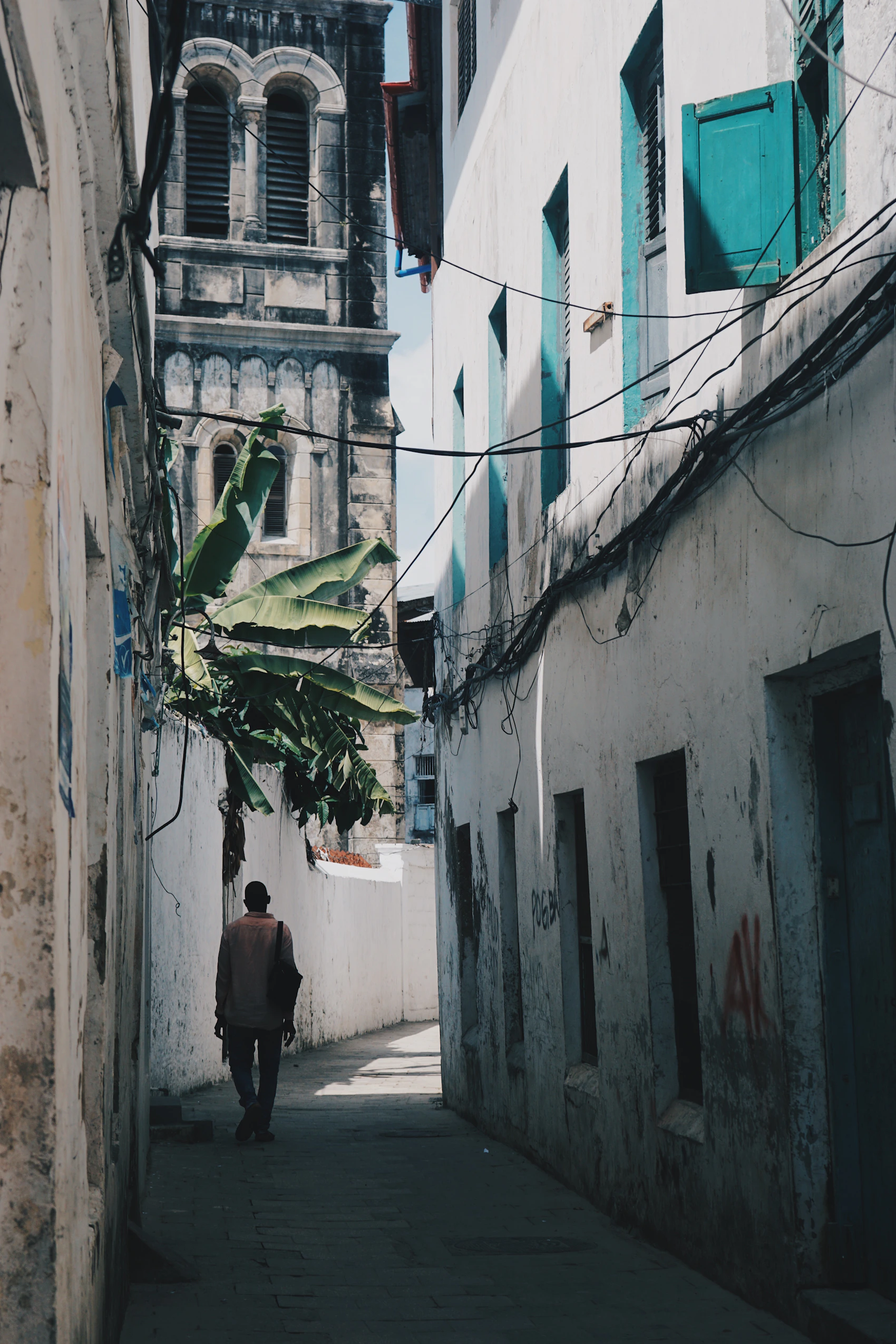 A narrow weathered lane between historic buildings in Stone Town, Zanzibar