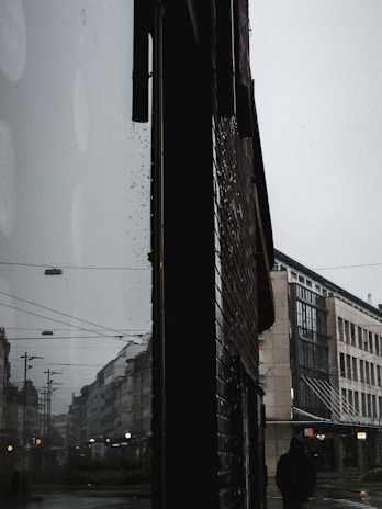 An atmospheric still from a short film showing a character in a moody urban setting.