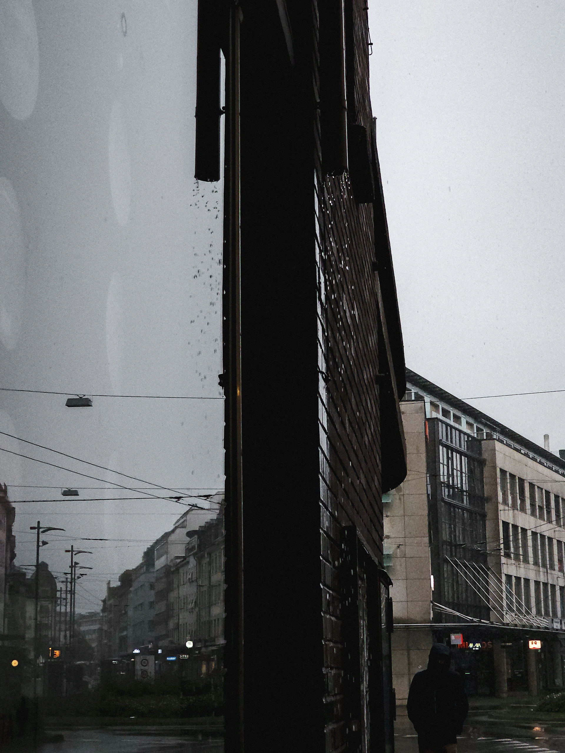 A moody, cinematic still of a lone figure walking down a rain-soaked city street at night, capturing the essence of a short story's suspense.