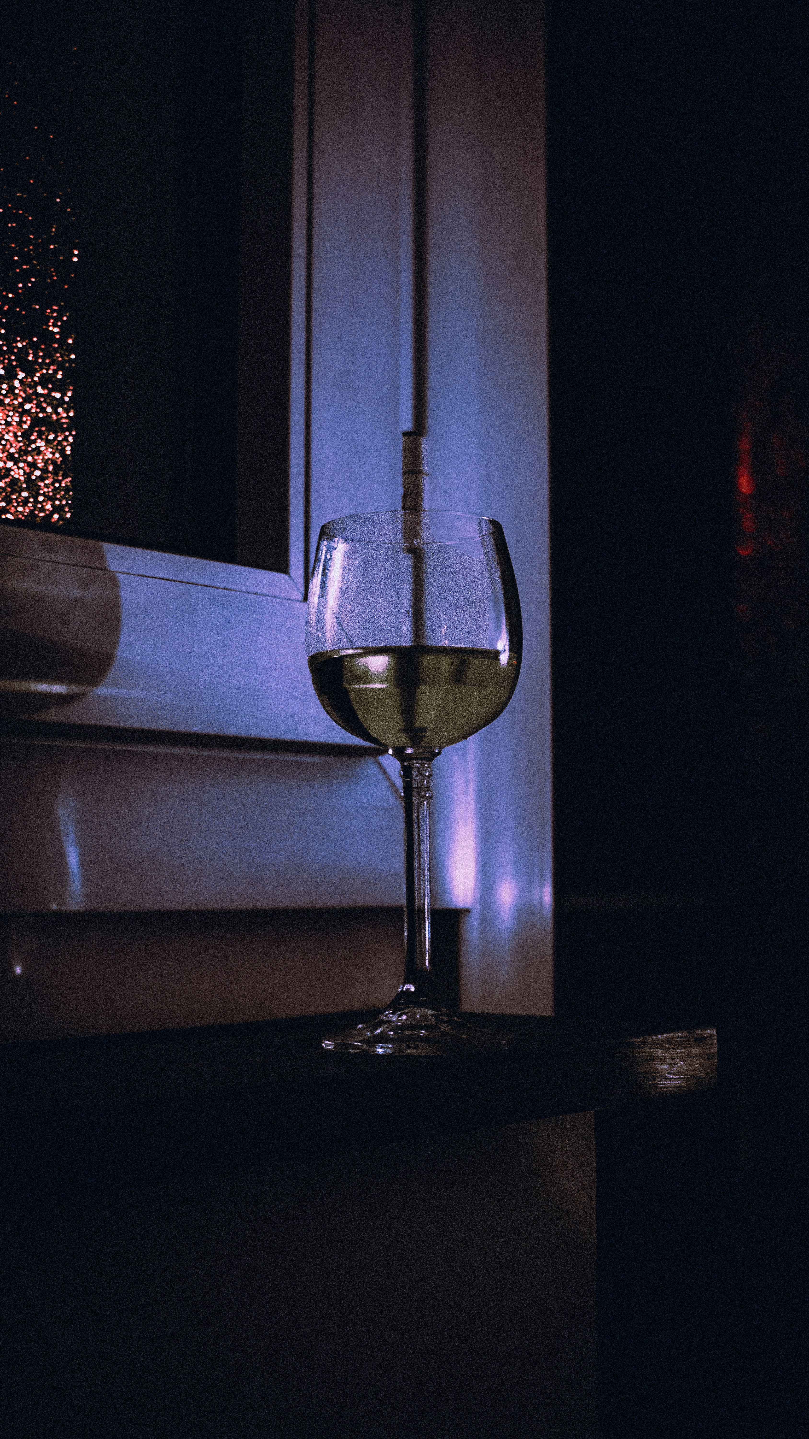 a glass of wine sitting on top of a table