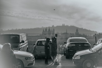 An image of a car being handed over between two people in a parking lot.