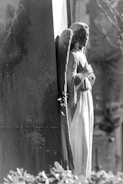 Soft grayscale image of a serene angel statue bathed in gentle light