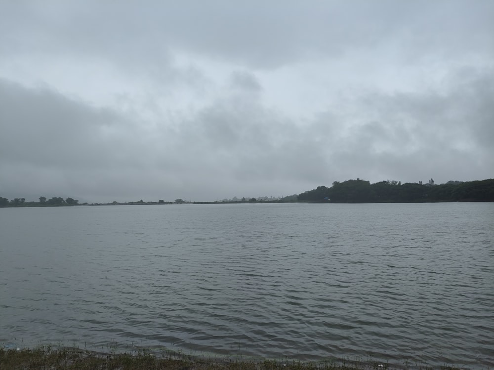 a body of water with a hill in the distance