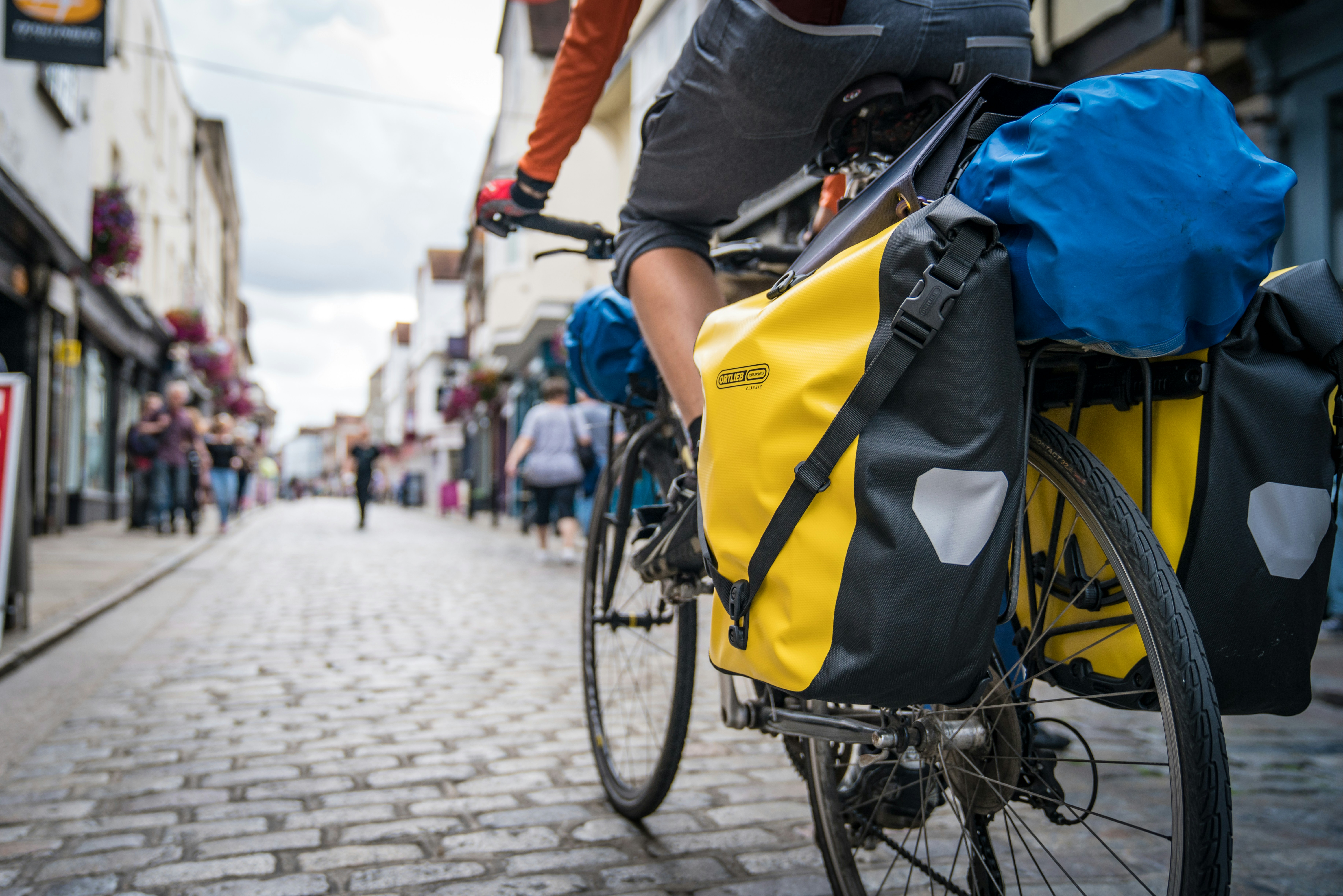 a person riding a bike down a cobblestone street