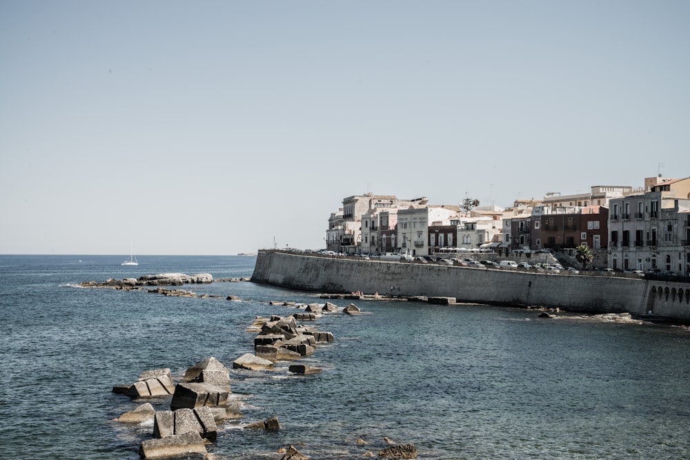 a body of water with buildings in the background