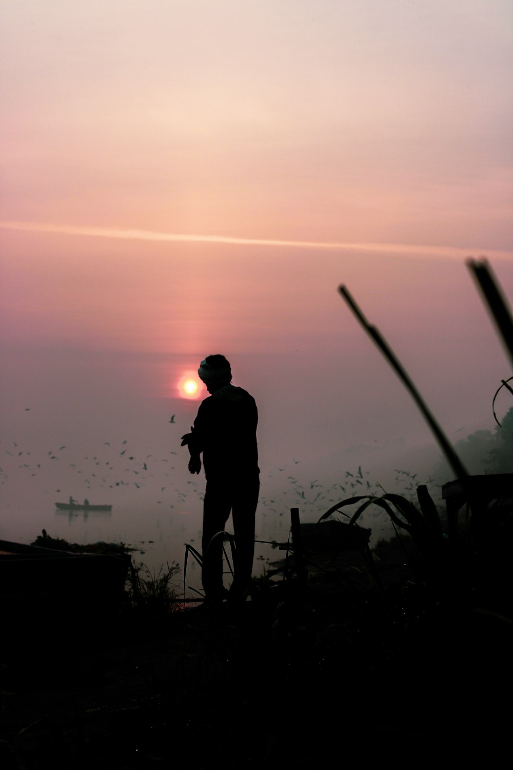 a man standing in front of a sunset