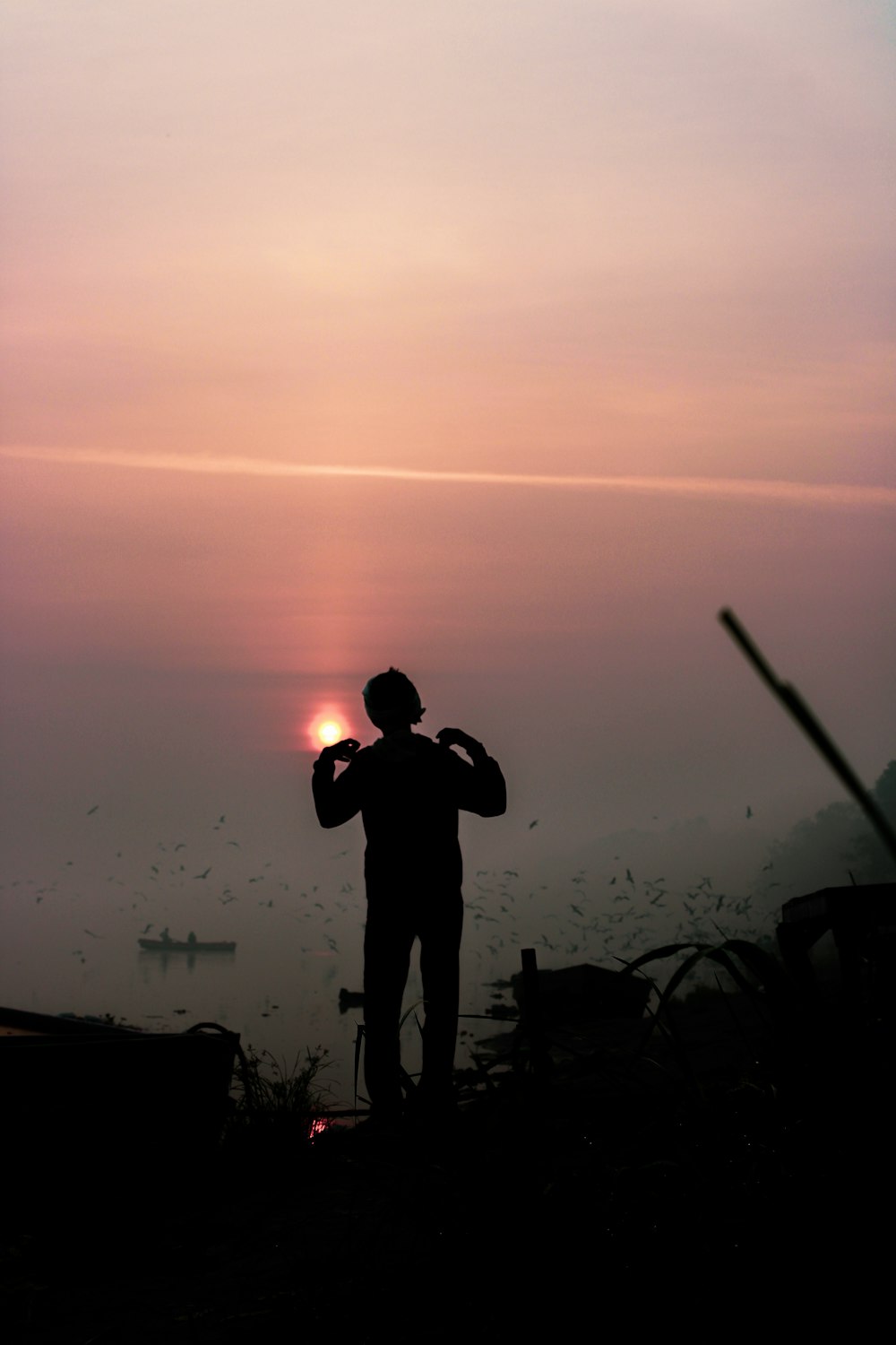 a silhouette of a man holding a baseball bat