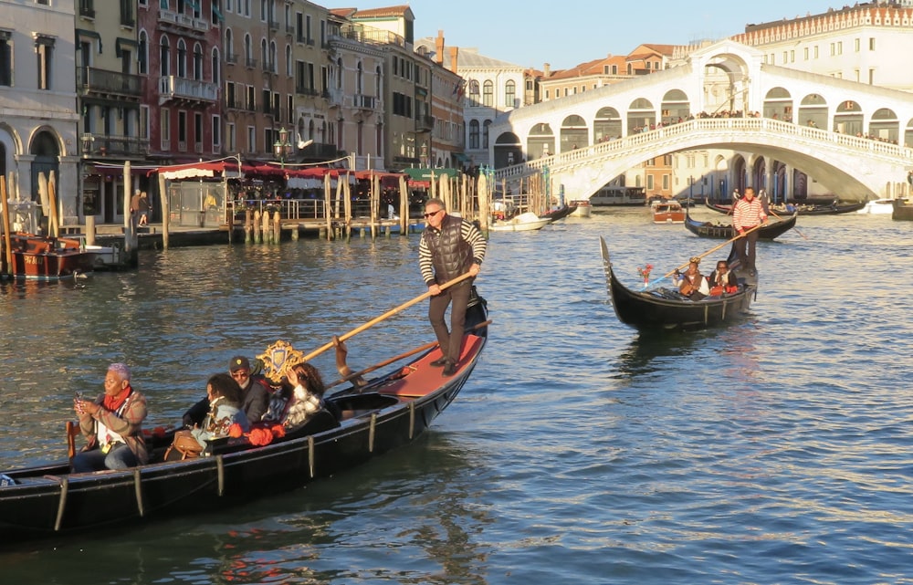 a group of people riding on top of a boat down a river