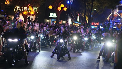 Group of friends wearing Halloween masks enjoying music near the festival bar.
