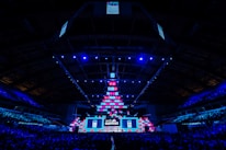 A dynamic esports event scene with vibrant lighting blending cool blue and white tones.