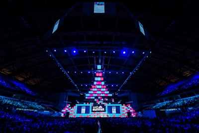 A dynamic esports event scene with vibrant lighting blending cool blue and white tones.
