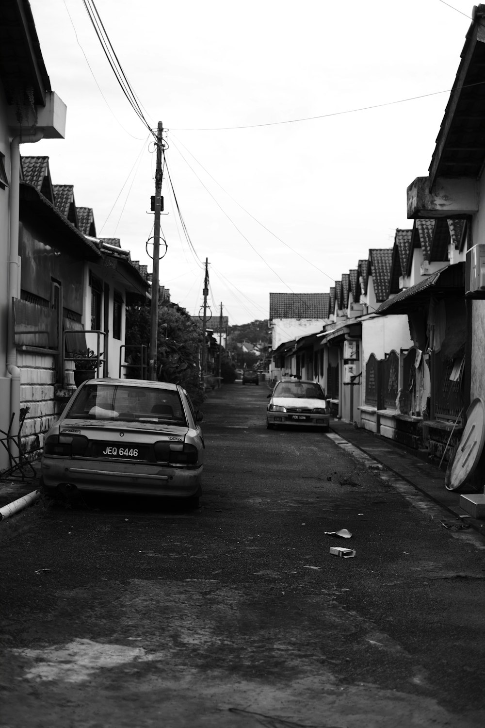 a black and white photo of a car parked on the side of a road