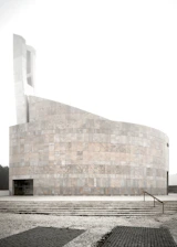 A serene modern building representing the Instituto Polieus-Monoeus headquarters.