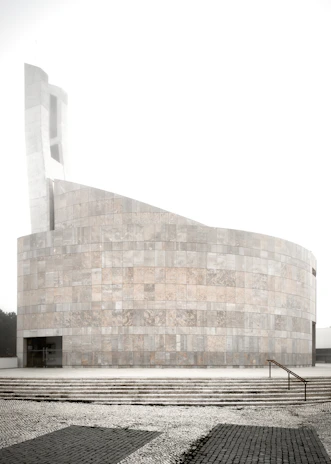 A serene modern building representing the Instituto Polieus-Monoeus headquarters.