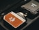 A close-up view of a device with a brown leather-like texture, branded 'Hobolite' and labeled with 'NFC' in a sleek, metallic case. The device is positioned next to a folded item with another 'Hobolite' label, all placed within a black fabric bag or case.