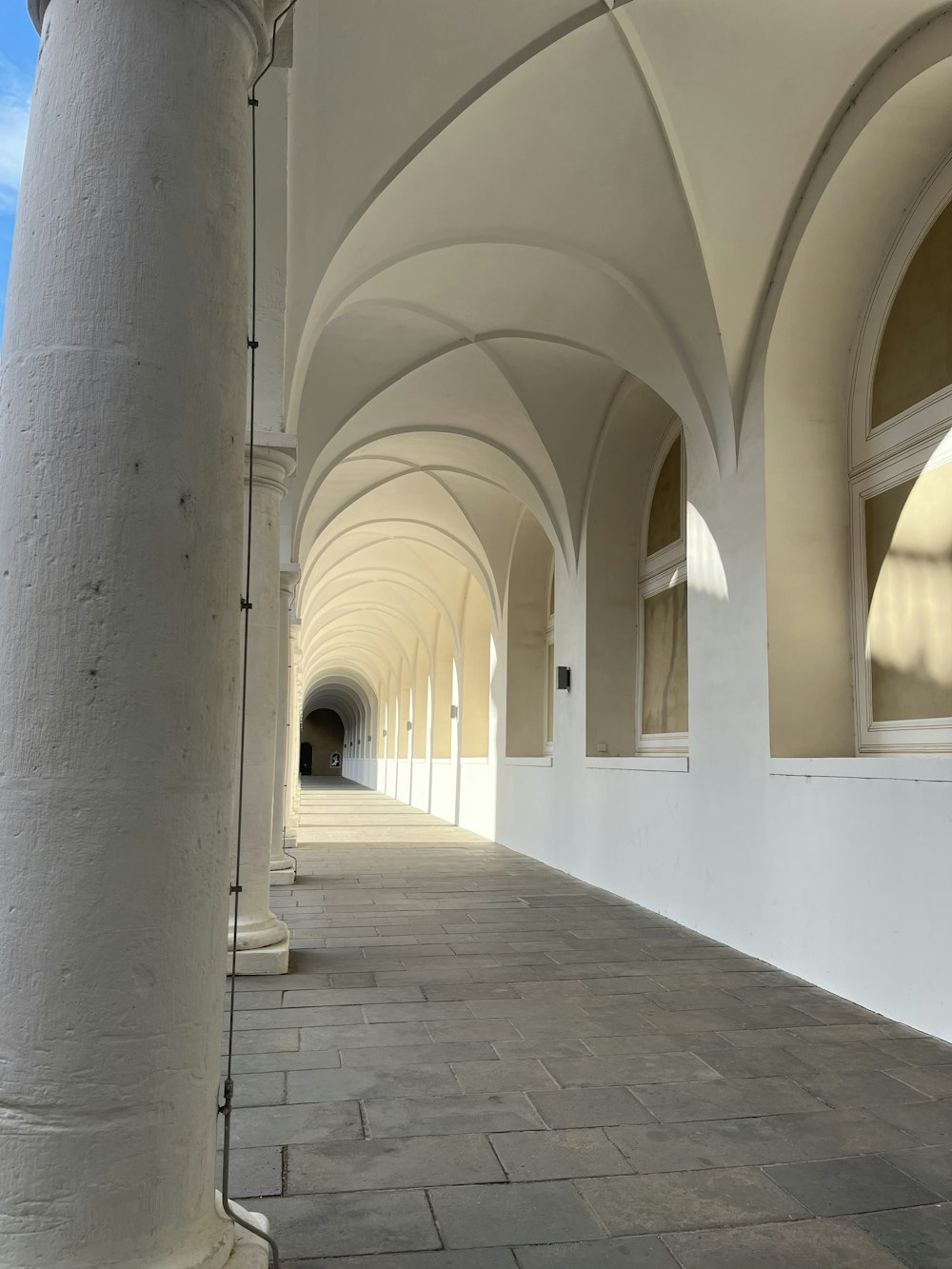 a long white building with arches and windows